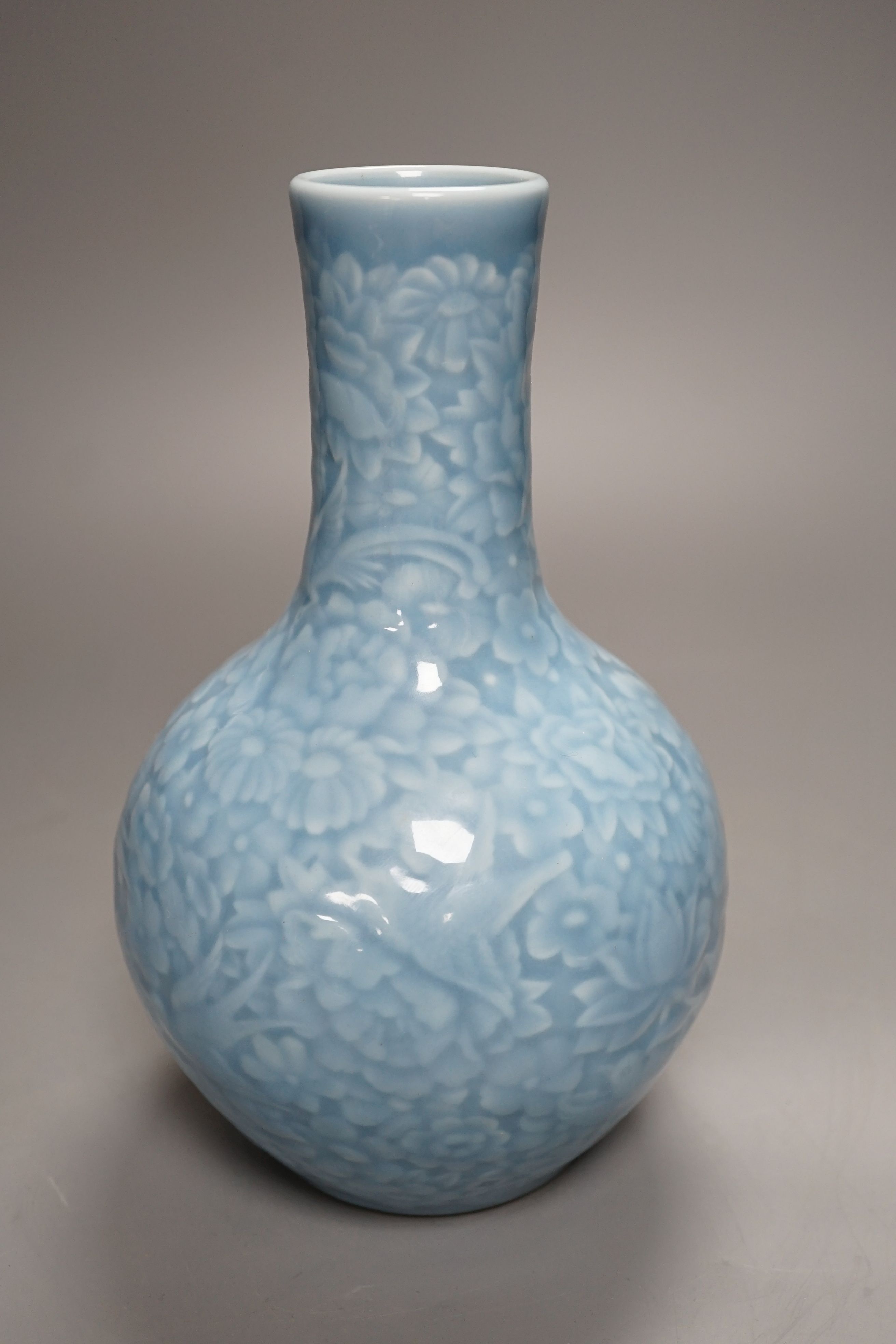 A Chinese blue-glazed moulded bottle vase - 23cm high